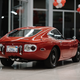 Illustration for article titled Hey, Let's Rob Some Banks To Buy This Perfect Left-Hand-Drive Toyota 2000GT